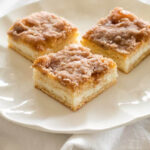 Slices of Sopapilla Cheesecake on a white plate, perfect for sharing