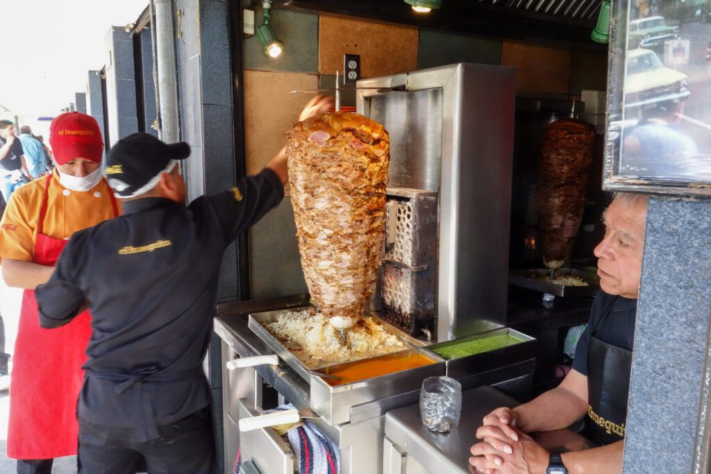 Tacos al pastor from El Huequito with cilantro and onion