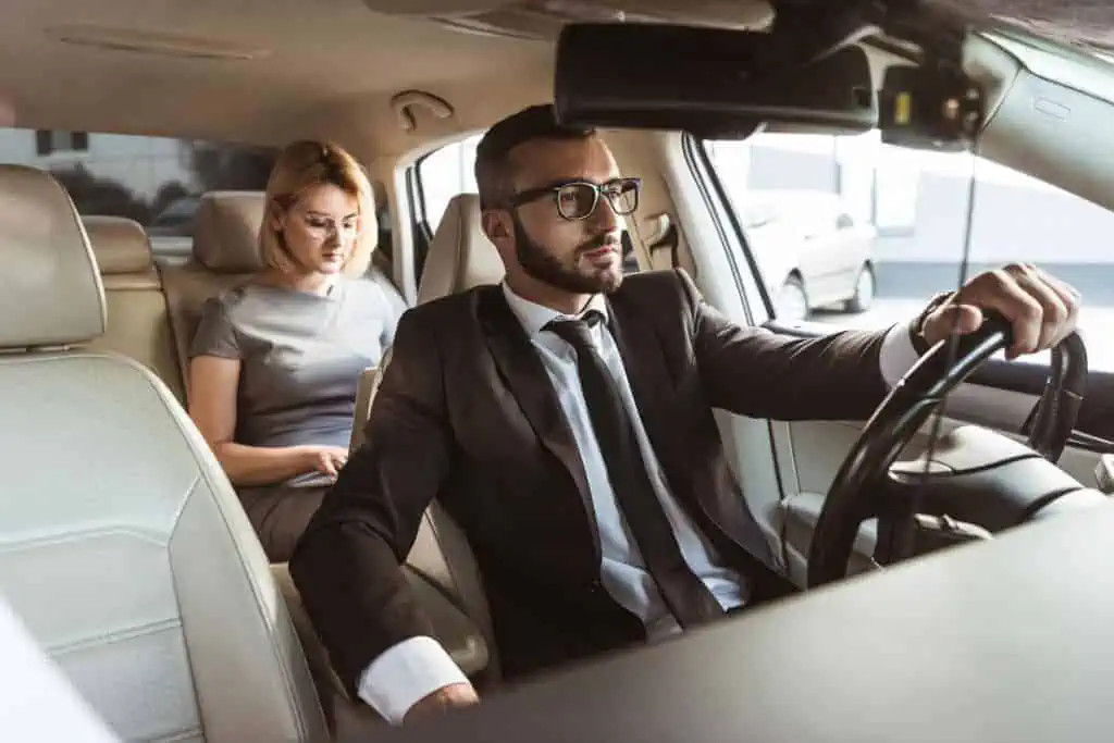 Driver with a woman in the back seat