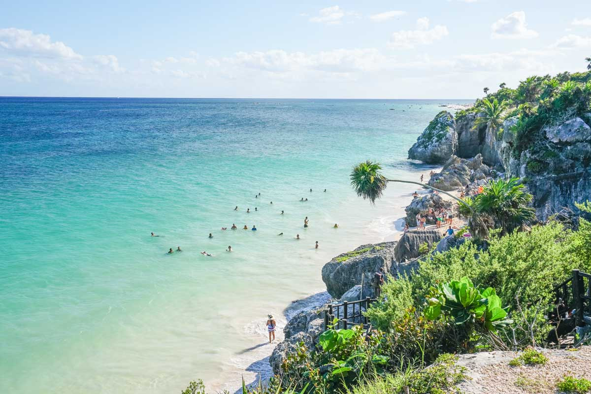 Aerial view of Tulum ruins perched on a cliff overlooking the turquoise Caribbean Sea
