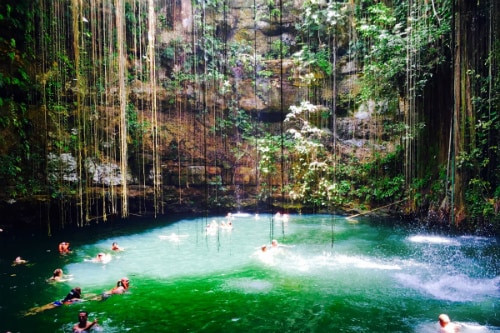People exploring the grand Chichen Itza pyramid