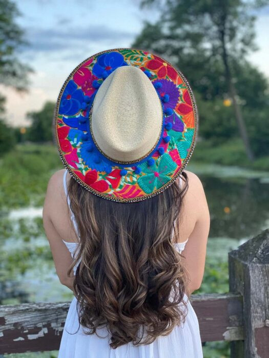 Man wearing a traditional guayabera shirt and sombrero, complemented by a colorful serape, perfect for a Mexican-themed party