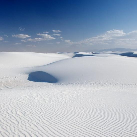 White Sands National Park, New Mexico, showcasing the vast expanse of gypsum dunes under a clear blue sky.