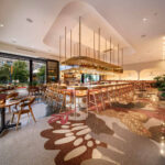 A corner booth at VERDAD True Modern Mexican, with a terrazzo bar in the background