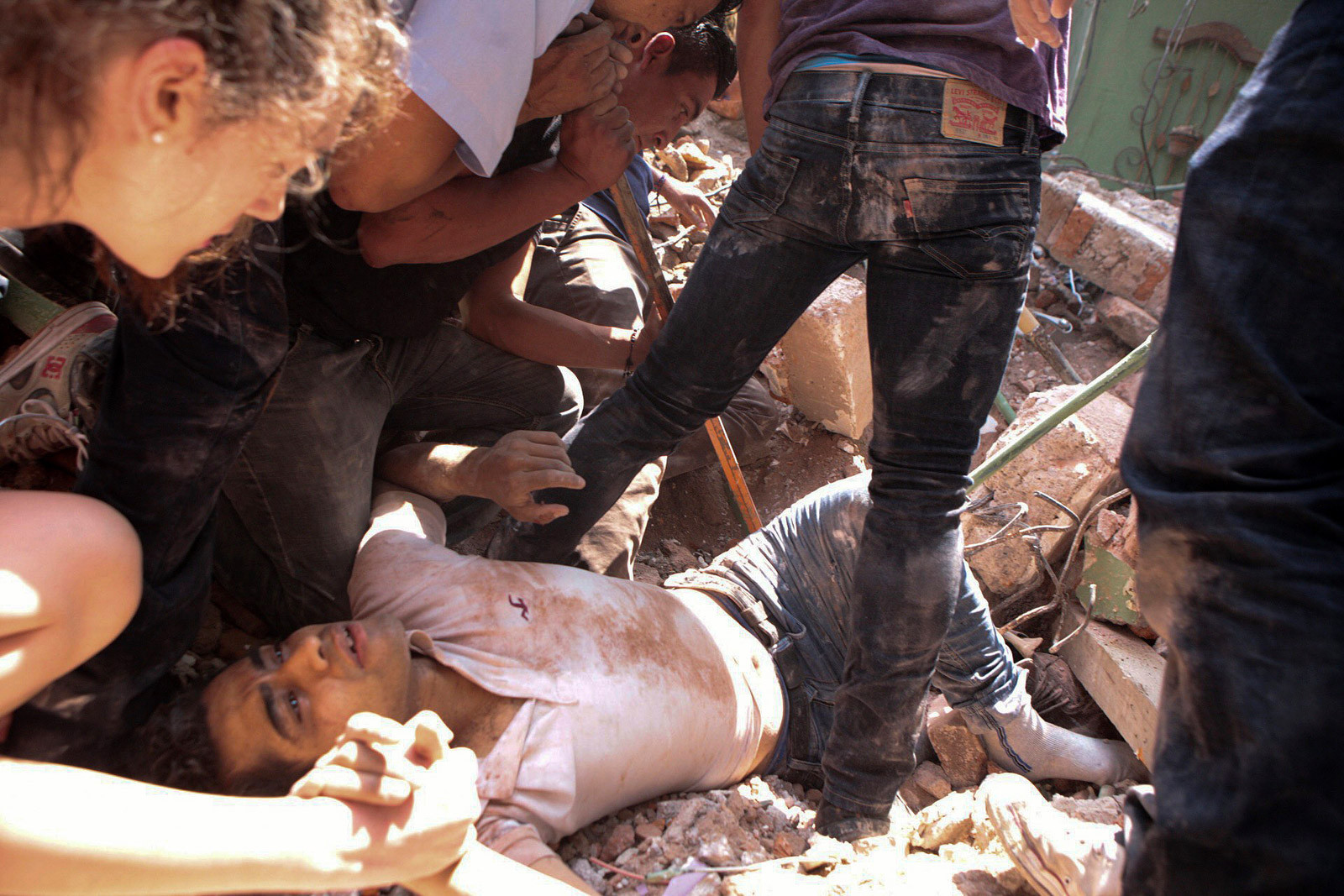 Man being rescued from a collapsed building in Mexico City's Condesa neighborhood following the earthquake