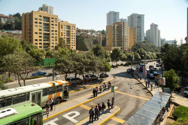 The bus stop for the official city buses to carry workers back to the city center from Santa Fe, highlighting the transportation infrastructure