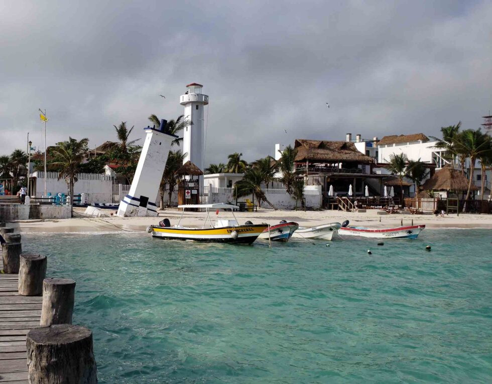 The Malecon of Puerto Morelos with a crooked lighthouse on the beach
