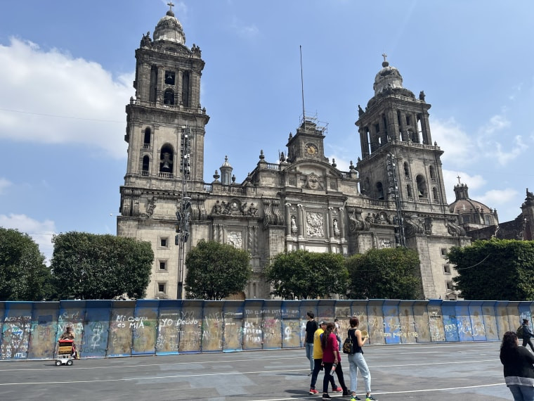 Graffiti covering barricades outside the Metropolitan Cathedral in Mexico City