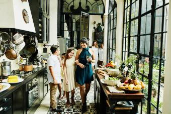 Smiling aunt and niece walking through kitchen