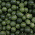 A close-up of lemons on a tree, alt text: A close-up view of ripe lemons hanging on a tree, symbolizing the natural abundance and agricultural heritage of Mexico.