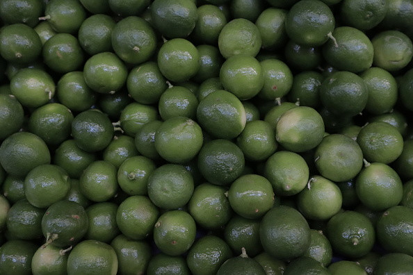 A close-up of lemons on a tree, alt text: A close-up view of ripe lemons hanging on a tree, symbolizing the natural abundance and agricultural heritage of Mexico.