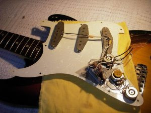 1969 Fender Stratocaster Pickups - A close-up of vintage Stratocaster pickups, highlighting their role in producing the guitar's signature sound.