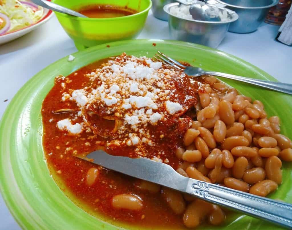 A plate of enchiladas, showcasing the saucy and cheesy goodness.