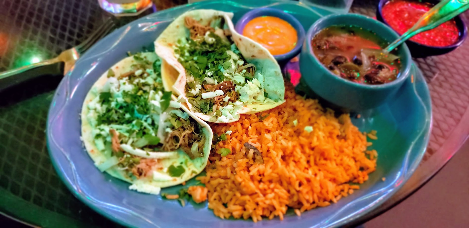 E Bar Tex-Mex's modern interior is complemented by a colorful mural, creating a stylish dining environment.