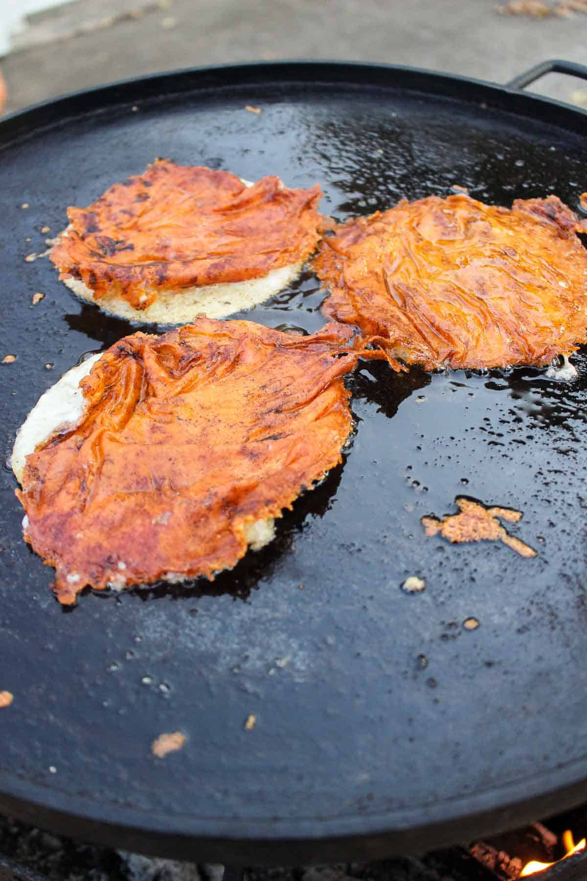 The flipped tortillas covered in melted cheese.