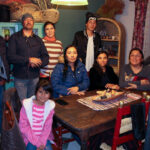 Apache community members in Chihuahua, Mexico, standing outdoors.