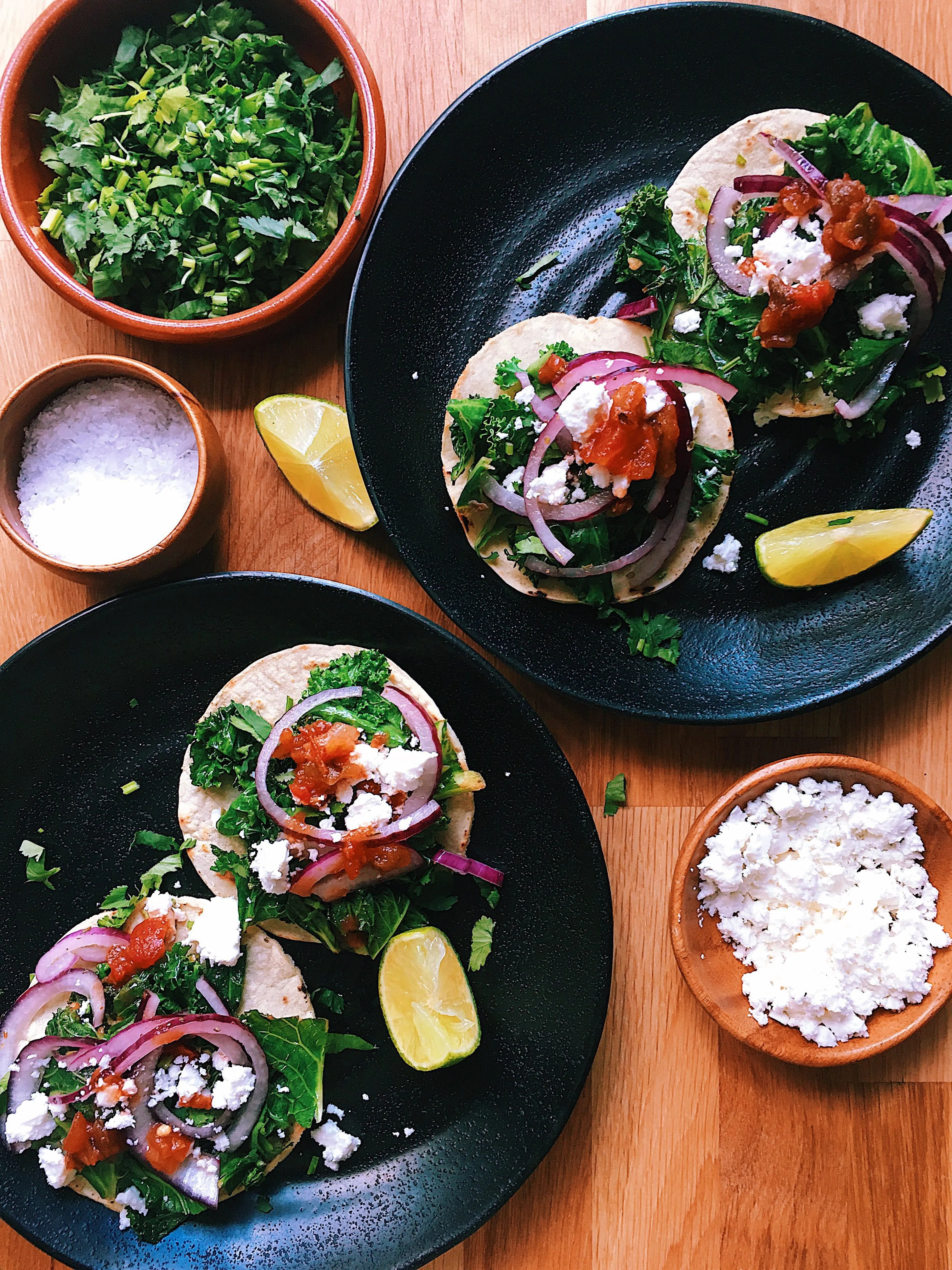 A vibrant street food stand in Mexico, showcasing a variety of taco fillings and toppings, capturing the essence of Mexican culinary culture.