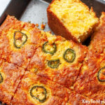 A baking dish containing slices of savory Mexican cornbread.