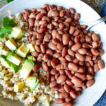 Mexican Pizza Topped with Beans, Queso, Jalapenos, Tomatoes, Cilantro and Avocado