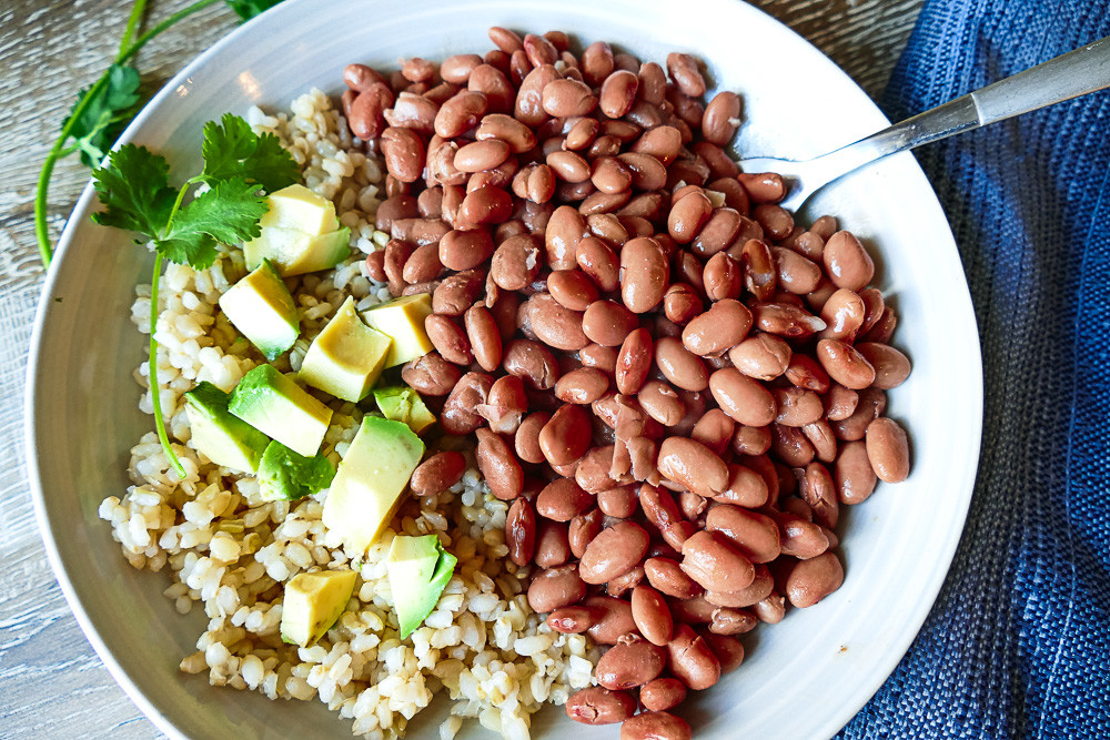 Mexican Pizza Topped with Beans, Queso, Jalapenos, Tomatoes, Cilantro and Avocado