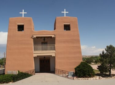 The Adobe Sacred Heart Catholic Church from the front and blue skies