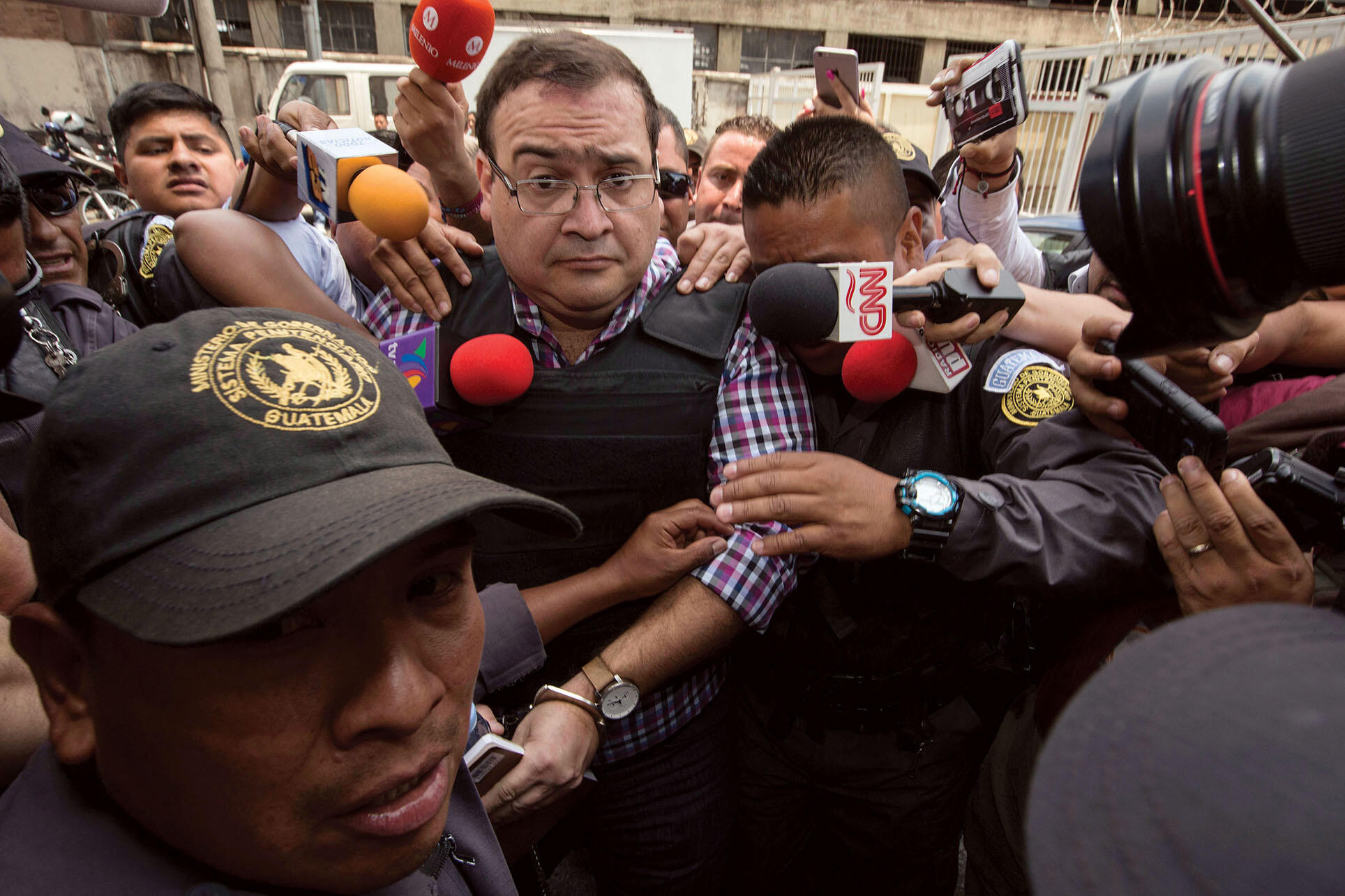 Mexico’s former governor of  Veracruz, Javier Duarte, is led through a crowd of reporters to an extradition hearing in Guatemala.