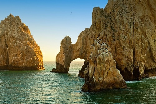 Cruise ship in Ensenada, Mexico, showcasing a vibrant port city with colorful buildings and clear blue waters