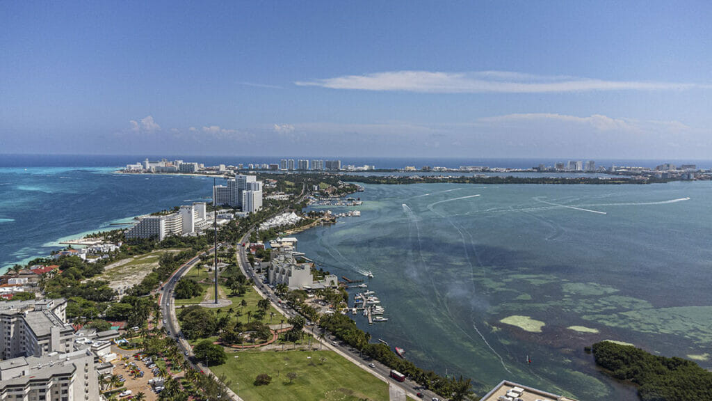 Cancun Hotel Zone view under a clear blue sky, representing the tourist-friendly environment.