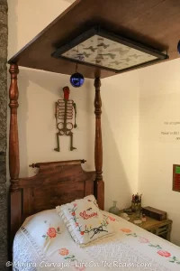A canopy bed with framed butterflies on the top part