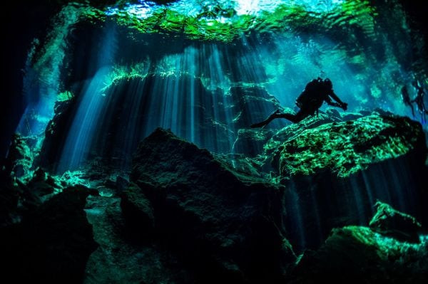 A diver explores the underwater beauty of Cenote Ik Kil in the Yucatan Peninsula.