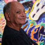 Cheech Marin in front of Leo Limon artwork