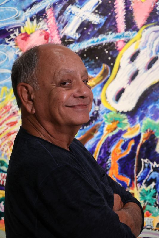 Cheech Marin in front of Leo Limon artwork