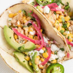 assortment of classic mexican street tacos with various fillings and toppings