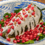 Chili in a white sauce with pomegranate seeds
