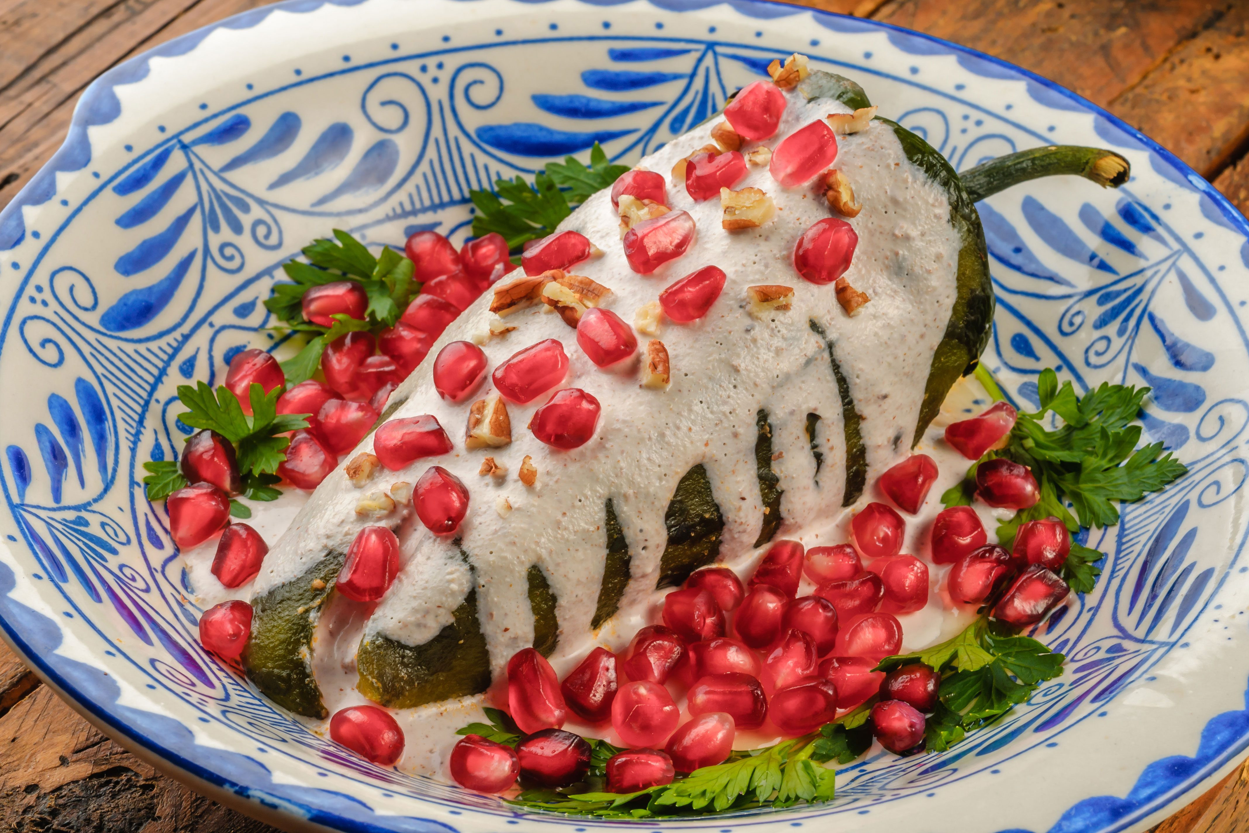 Chili in a white sauce with pomegranate seeds