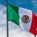 A colorful street scene in Puerto Vallarta with rainbow flags waving