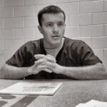 John Gamble, incarcerated for a crime committed as a juvenile, playing guitar in prison.