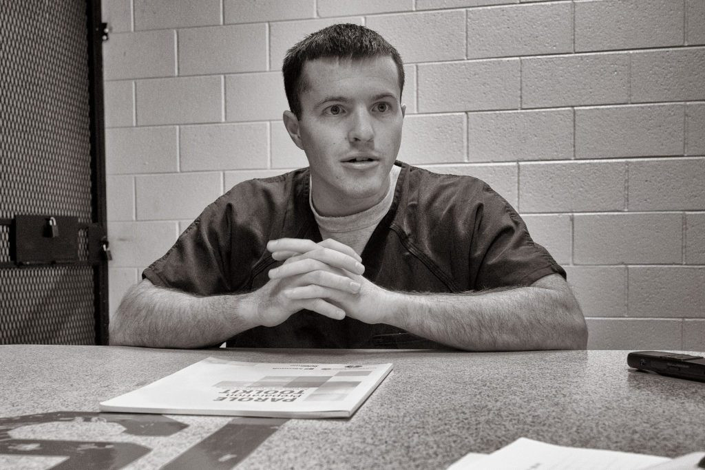 John Gamble, incarcerated for a crime committed as a juvenile, playing guitar in prison.