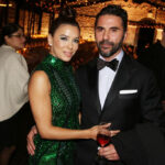 Eva Longoria and her husband Jose Baston posing at a formal dinner