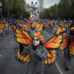 Women characterized as monarch butterflies perform during the Day of the Dead Parade in Mexico City.