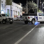 Members of the investigative police stand next to bodies wrapped in blankets and covered with duct tape left by unknown persons on a street in Fresnillo, Zacatecas, Mexico, May 7, 2024, highlighting the severity of the situation in the area.