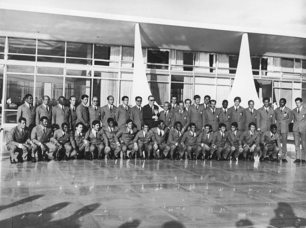 Brazilian Military President Emilio Garrastazu Médici holding the Jules Rimet trophy with national team members, symbolizing the regime's influence on the 1970 World Cup victory.