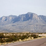 Scenic view of Guadalupe Mountains from a highway near Carlsbad, New Mexico, showcasing the natural beauty of the region