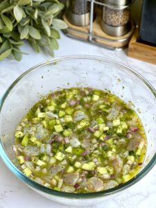Marinating the shrimp in blended cilantro, serrano, and lime juice