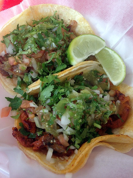 Close-up of authentic Mexican al pastor tacos with toppings