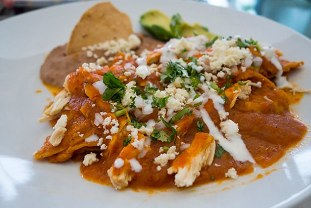 Overhead shot of a Chilaquiles dish with various toppings