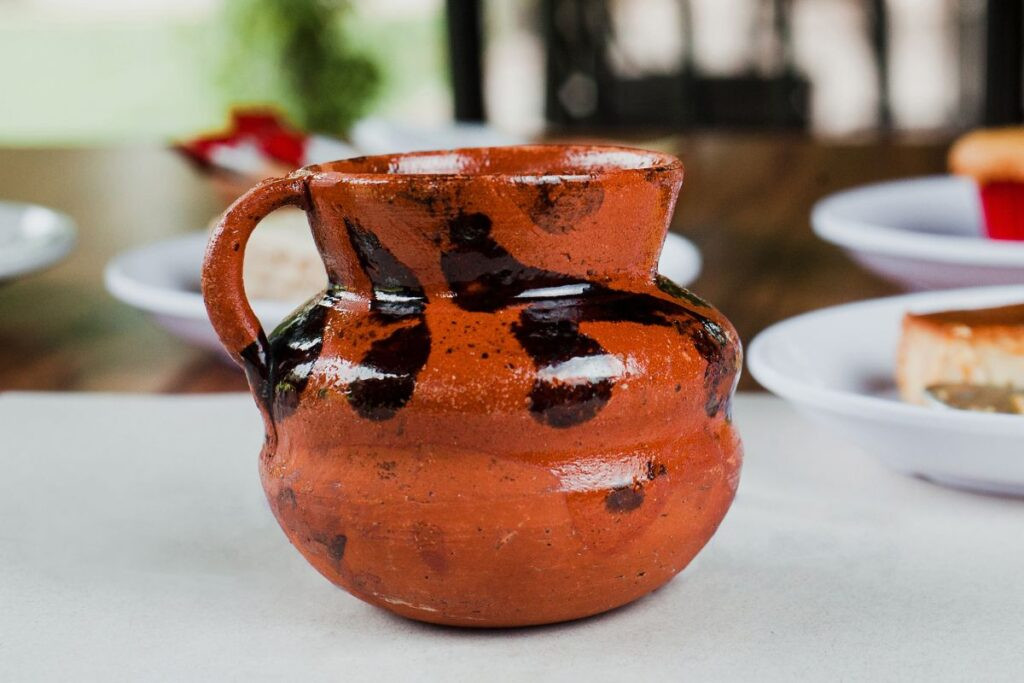 A colorful Jarrito mug, hand-painted and made of clay