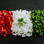 Mexican flag shaped with chopped tomatoes white onion and jalapeño