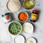 Ingredients for making Mexican rice including rice, tomato sauce, onion, garlic, oil, tomato bouillon, water, salt, peas, and carrots