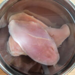 Brining chicken breasts in a bowl